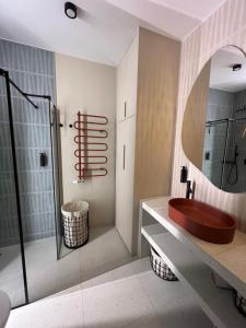 a bathroom with a red sink and a mirror at WIDOKI3 Apartment Montownia Foodhall in Gdańsk +58 photos