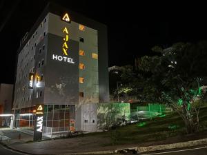 a hotel with a sign on the side of it at night at Ajax Hoteis in Colatina