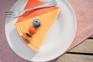 a piece of cake on a white plate with a fork at Klostermaier Hotel & Restaurant in Icking