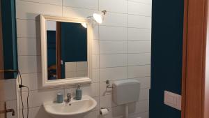 a bathroom with a sink and a mirror at Palazzo montagna in Grotte