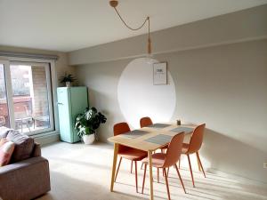 a dining room with a table and chairs at Felix De Haan in De Haan