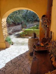 an archway in a room with a stone patio at Casa Asilo La Foce, Val d' Orcia, Pienza. in Pienza