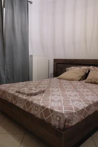 Posteľ alebo postele v izbe v ubytovaní όμορφο διαμέρισμα με αυλή