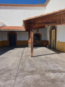 a patio of a house with a wooden roof at Cuevas CEMAR in Guadix