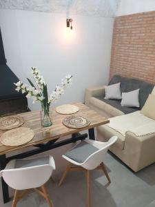 a living room with a table and a couch at Cuevas CEMAR in Guadix
