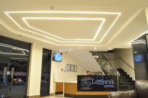 a lobby with a coffered ceiling and stairs at Lazzarus Hotel - Suíte Family in Alexânia