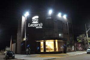 a building with a sign on it at night at Lazzarus Hotel in Alexânia