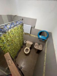 a small bathroom with a toilet and a sink at Constellation Hotel 3 in Dajabón