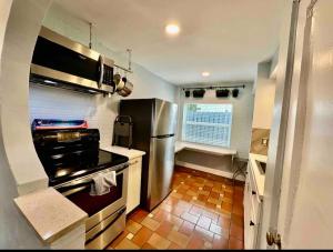 a kitchen with a stove and a refrigerator at Central & Stylish Oasis Slps 2 in Fort Lauderdale