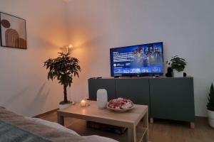 a living room with a tv and a coffee table at Spacious 2 Bedroom Apartment with Court yard - Antwerp Smooth Stays in Antwerp
