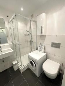 biała łazienka z toaletą i prysznicem w obiekcie Premium Studio Grafenberg w mieście Düsseldorf