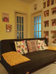 a black couch with pillows in a living room at Casa Ciano in Foggia