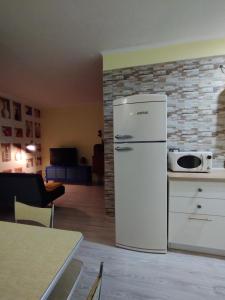 a kitchen with a white refrigerator in a room at Casa Ciano in Foggia