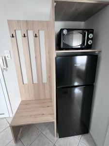 a microwave on top of a refrigerator in a kitchen at Presidential Palace 2 in Drama +9 photos