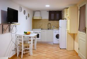 a kitchen with a table and a white refrigerator at Mirose's holiday home 39 in Castelbuono