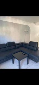 sala de estar con sofá azul y mesa en Escapade cosy proche Vienne, en Chasse-sur-Rhône