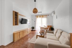 a living room with a couch and a table at A spacious and cozy apartment. in Torrevieja