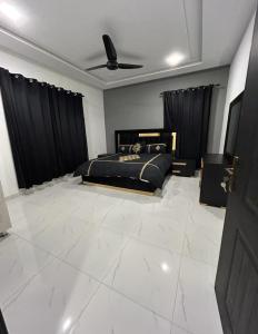 a bedroom with a black bed and black curtains at Superior Villa in Mirpur city Azad kashmir 