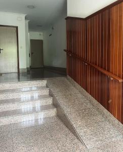 a room with stairs and a wooden wall at O fogar do camiñante in Redondela