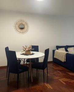 a dining room with a table and chairs and a bed at O fogar do camiñante in Redondela