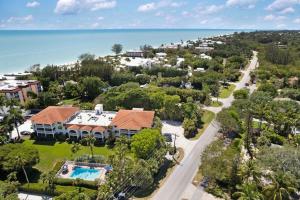 an aerial view of a house with a swimming pool and the ocean at Gorgeous Top Floor Beach Condo at Breakers West in Sanibel