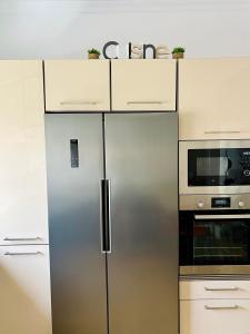 a kitchen with a stainless steel refrigerator and a microwave at Roque's House in Telde +32 photos
