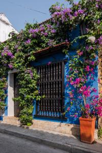 a blue building with flowers on it at Casa Familiar - Maria de las Palmas -Getsemani in Cartagena de Indias