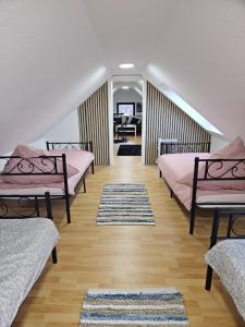 a room with three beds and a hallway with a desk at Schön und bequem Wohnung in Althengstett