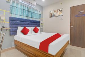 a bedroom with a bed with red and blue accents at OYO Flagship Luxury Rooms in Hyderabad