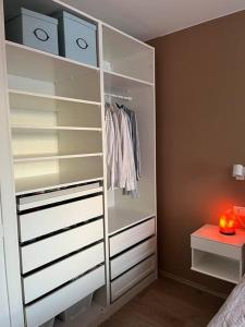 a closet with white shelves and a table in a room at Apartment in Hafnarfjörður in Hafnarfjördur