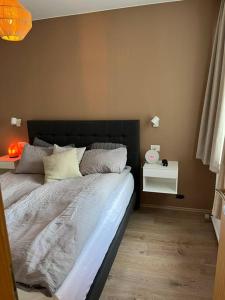 a bedroom with a bed with a black headboard at Apartment in Hafnarfjörður in Hafnarfjördur