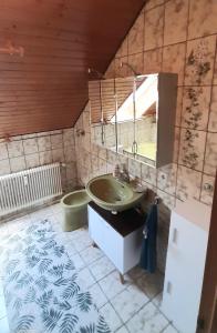 a bathroom with a sink and a mirror at Schön und bequem Wohnung in Althengstett +35 photos