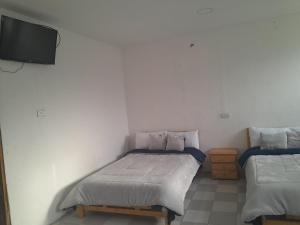 Postel nebo postele na pokoji v ubytování Hotel Mahoma