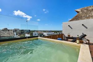 a swimming pool on the roof of a house at Bakal Residence By Ruha in Tulum