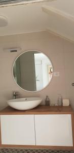 a bathroom with a white sink and a mirror at Guesthouse Augusta Insula in Lastovo