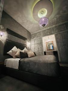 a bedroom with a large bed with a purple ceiling at Essaouira cosy in Essaouira