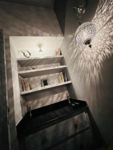 a room with a book shelf with a chandelier at Essaouira cosy in Essaouira