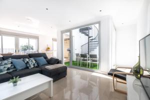 a living room with a couch and a table at House near the beach w sea view in Arico