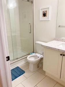 a white bathroom with a shower and a toilet at Beautiful House in Brampton Area, ON Canada in Brampton