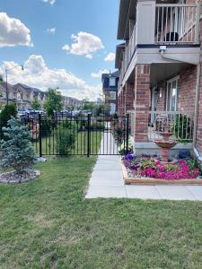 a fence in front of a house with flowers at Beautiful House in Brampton Area, ON Canada in Brampton