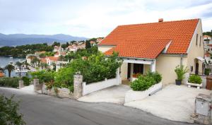 a white house with an orange roof at Apartments Boro in Splitska