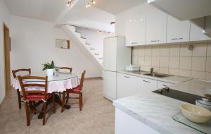 a kitchen with a table and chairs in a room at Apartments Boro in Splitska