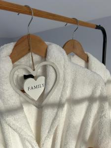a heart with the word family hanging on a towel at Casa do Sorrio in Viana do Castelo