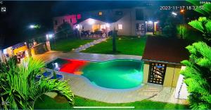 a swimming pool in front of a house at night at ωιℓℓу'ѕ νιℓℓα in Jarabacoa