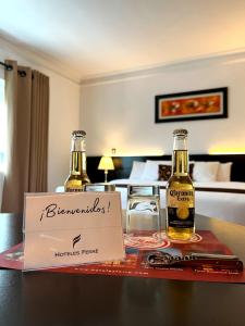 two bottles of beer on a table in a hotel room at Hotel Ferre De Ville in Lima