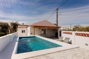 a swimming pool on the back of a house at Country Pool House 27 in Abrantes