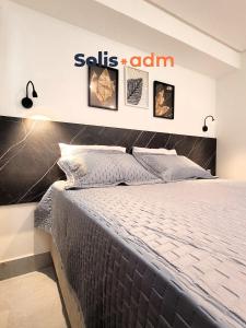 a bedroom with a bed and a sills alarm sign at Apart-hotel Beira-Mar em Manaíra in João Pessoa