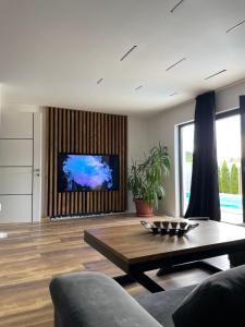 a living room with a coffee table and a tv at Apartments B&M in Visoko