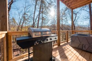 a grill on the deck of a cabin with a stove at Romantic Cabin Retreat By Ghosal Luxury Lodging in Gatlinburg