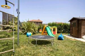 a childrens play area with a trampoline and a playground at tropical loft in Salemi